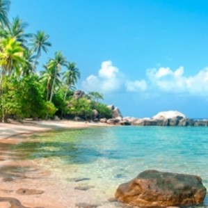 a beach in blue day light. geen trees, sea and sand